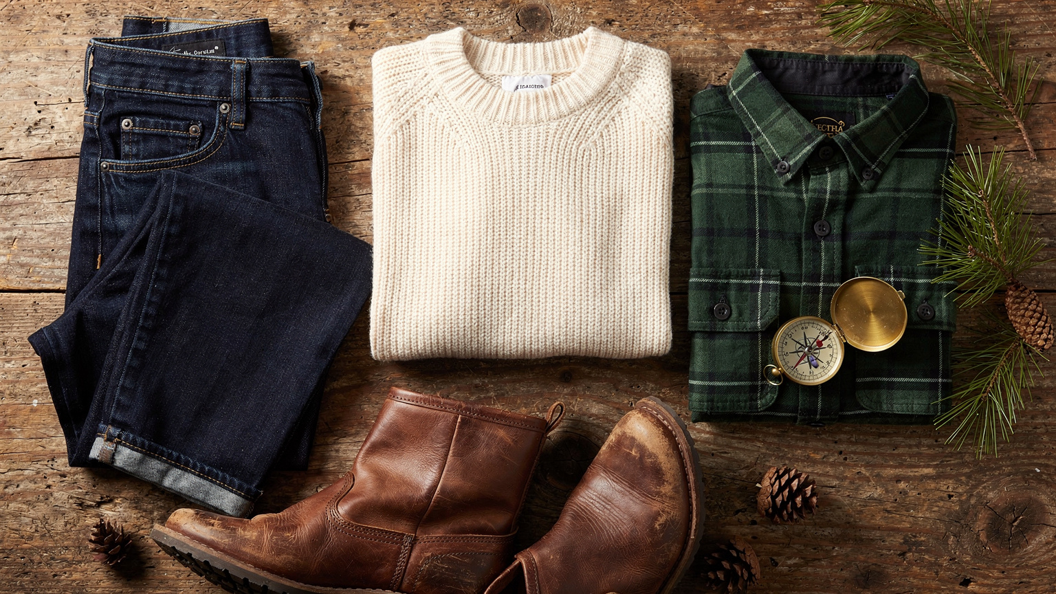 Coordinated outfits and accessories for Colorado engagement photos laid on wood